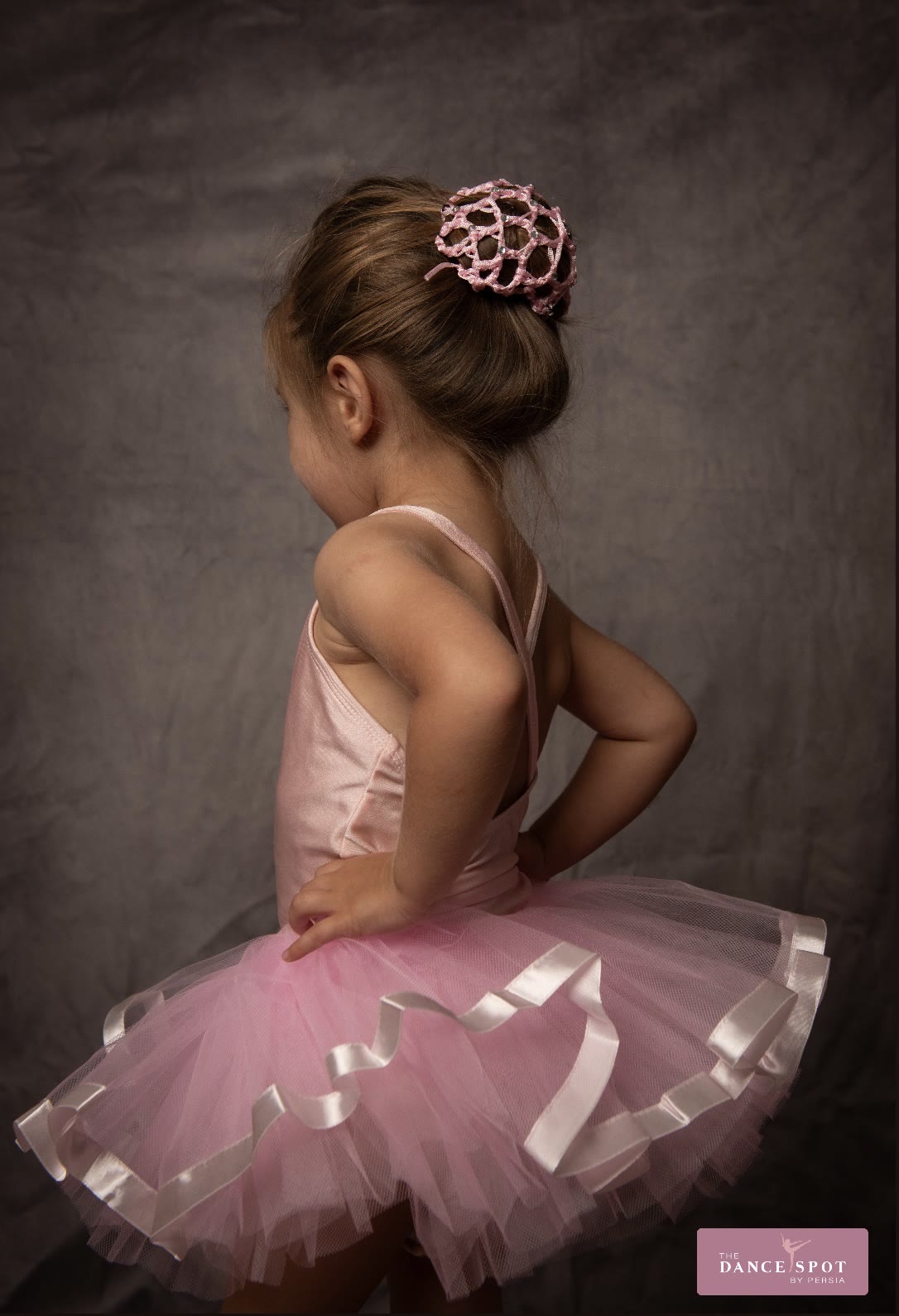 Young ballerina posing in a pink tutu
