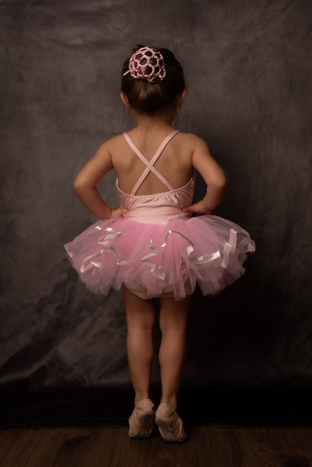Little ballerina in a pink tutu seen from behind