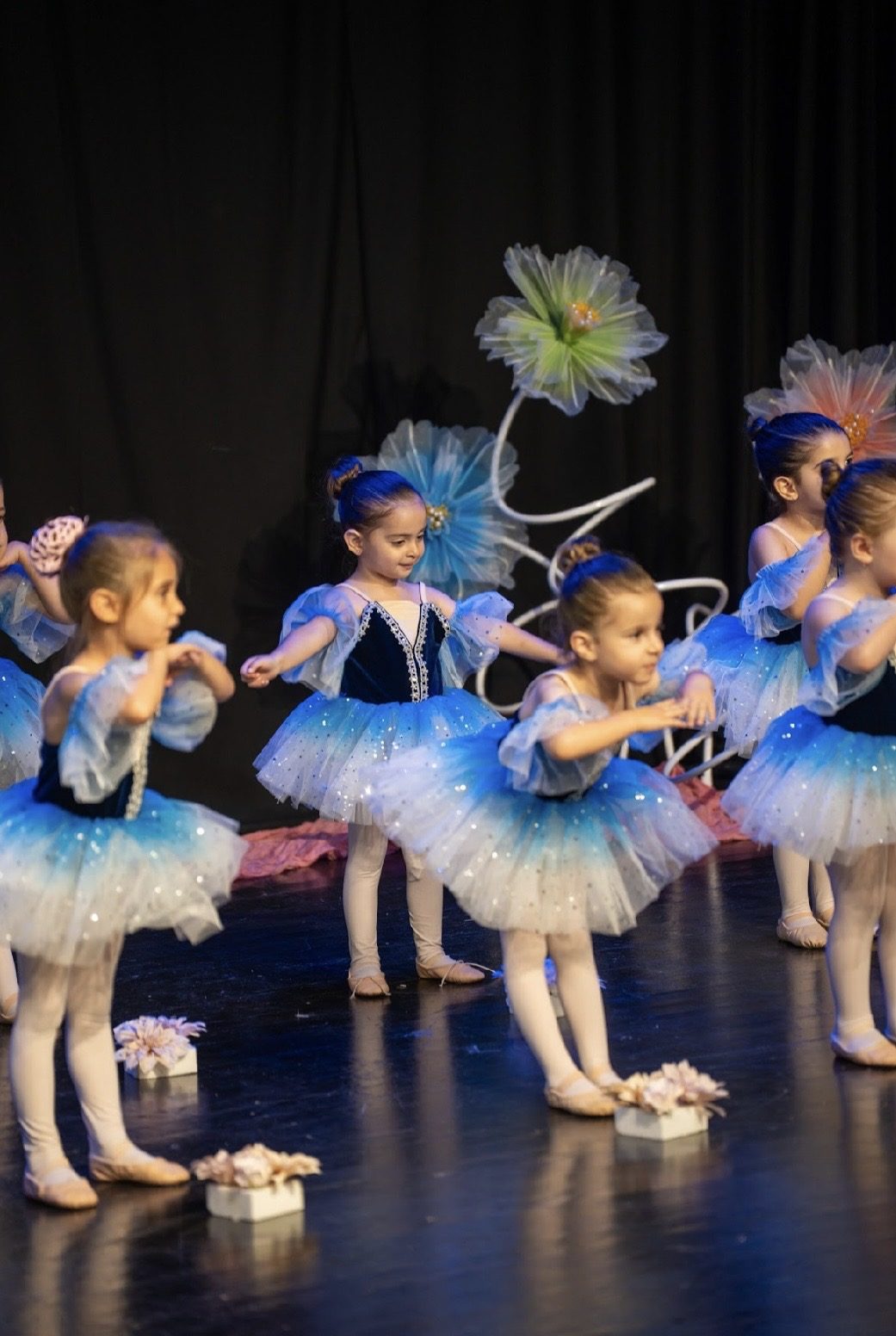 Tiny ballerinas performing in blue tutus