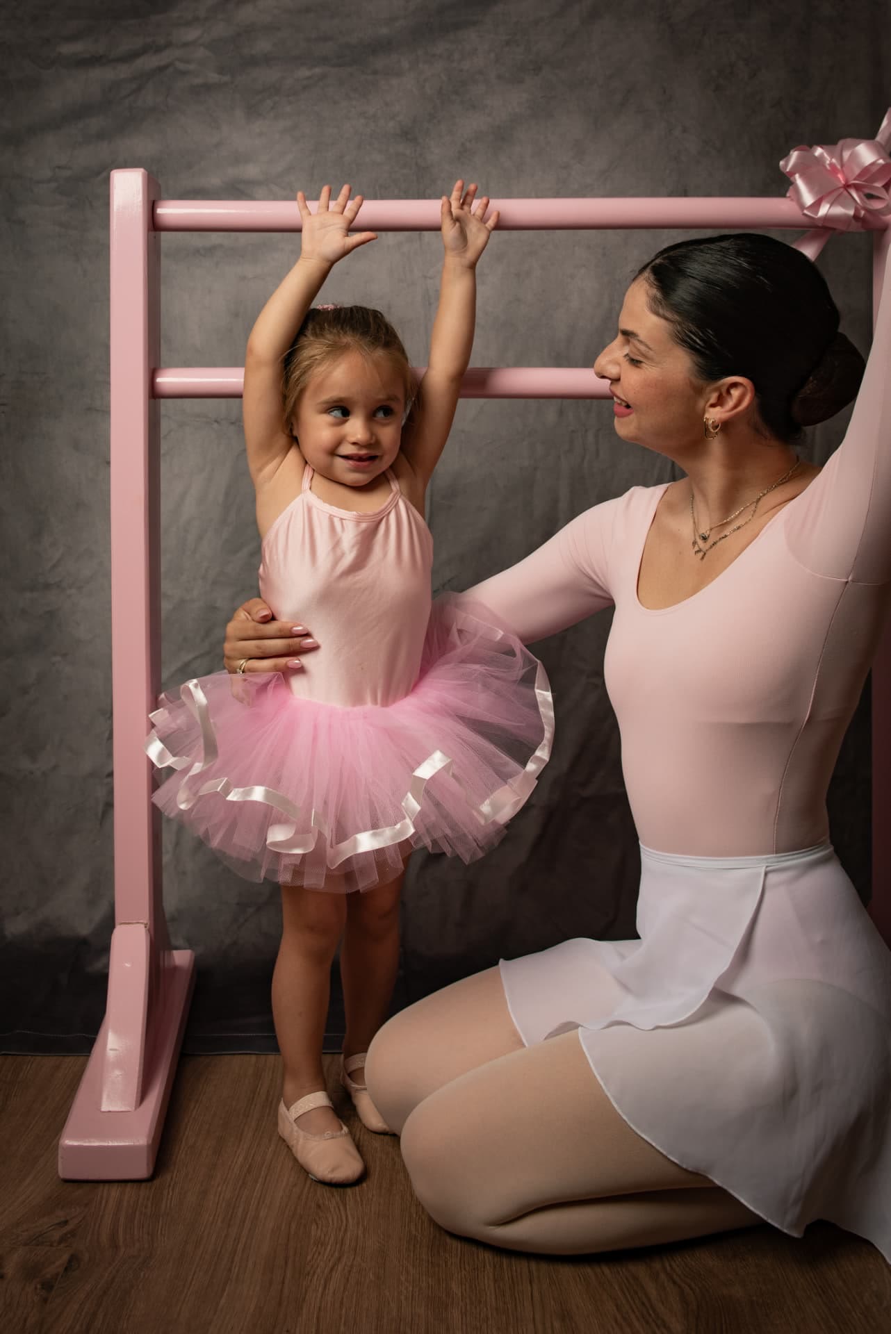 Persia guiding a little ballerina at the pink barre
