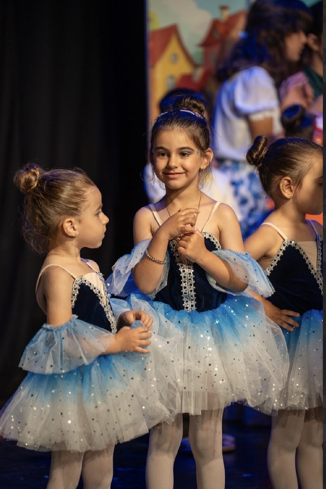 Ballerinas holding hands before their performance
